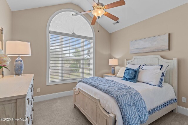 bedroom with lofted ceiling, light colored carpet, baseboards, and ceiling fan