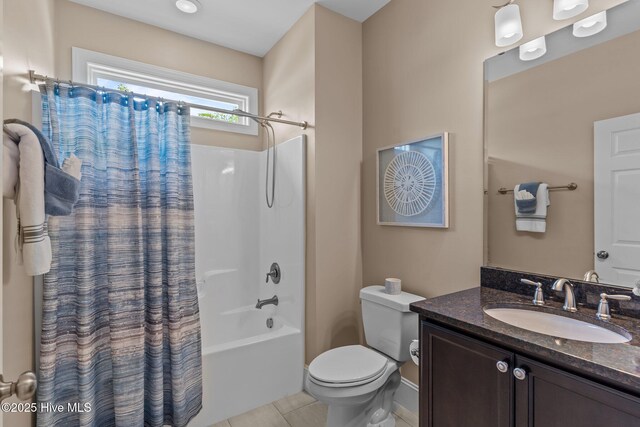 bathroom with tile patterned flooring, vanity, shower / bath combo with shower curtain, and toilet