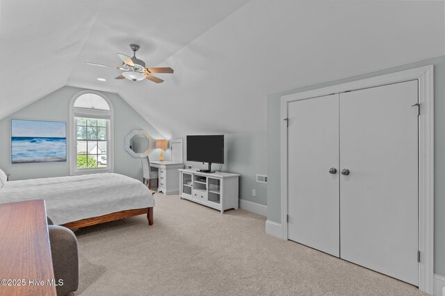 bedroom with carpet flooring, lofted ceiling, baseboards, and ceiling fan
