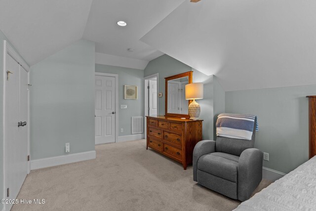 bedroom with lofted ceiling, carpet floors, and baseboards
