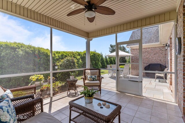 sunroom with ceiling fan, an outdoor hangout area, and outdoor dining space