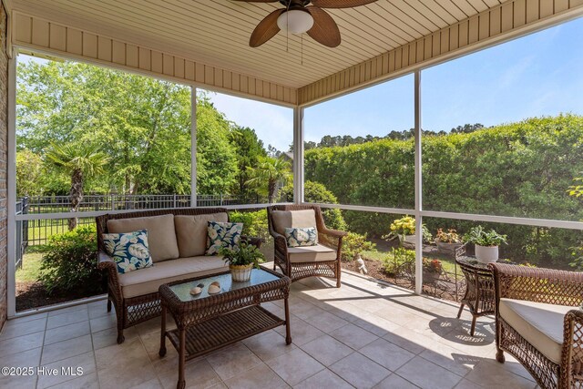 sunroom / solarium featuring ceiling fan and outdoor lounge area