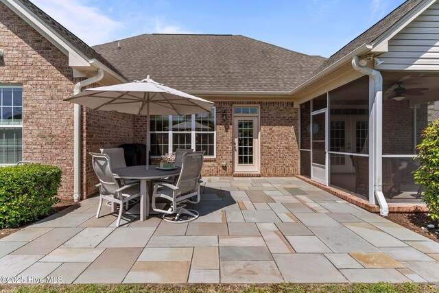 view of patio / terrace featuring outdoor dining area, ceiling fan, french doors, and a sunroom