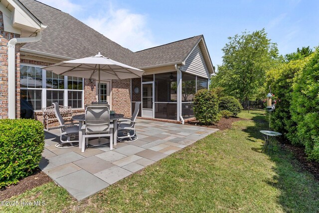 view of patio / terrace featuring a sunroom and ceiling fan