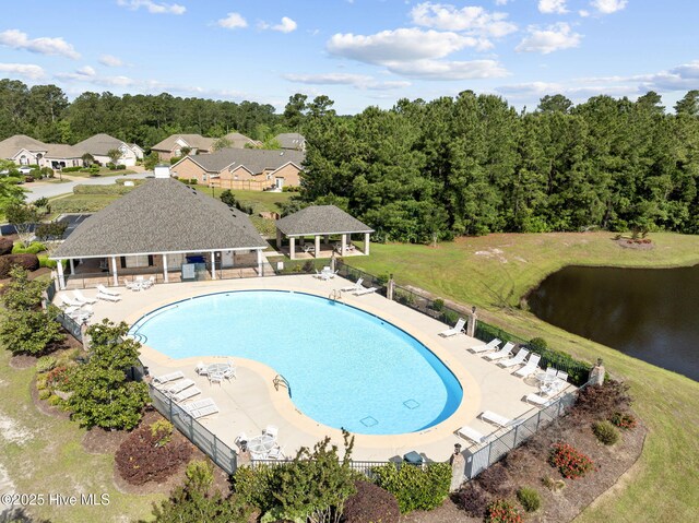 community pool featuring fence, a gazebo, and a water view