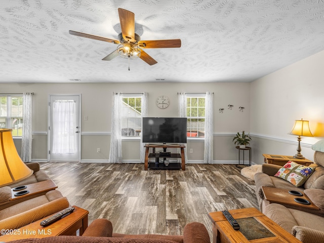 102 Flat Rock Ln, Richlands, NC 28574 - living area with wood finished floors, a textured ceiling, ceiling fan, and baseboards