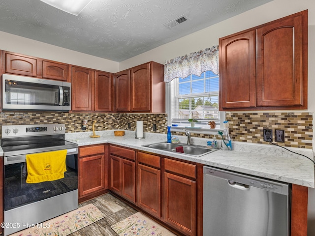 102 Flat Rock Ln, Richlands, NC 28574 - kitchen featuring appliances with stainless steel finishes, a sink, light countertops, and decorative backsplash
