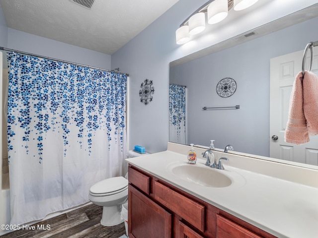 102 Flat Rock Ln, Richlands, NC 28574 - bathroom featuring wood finished floors, toilet, vanity, and shower / tub combo