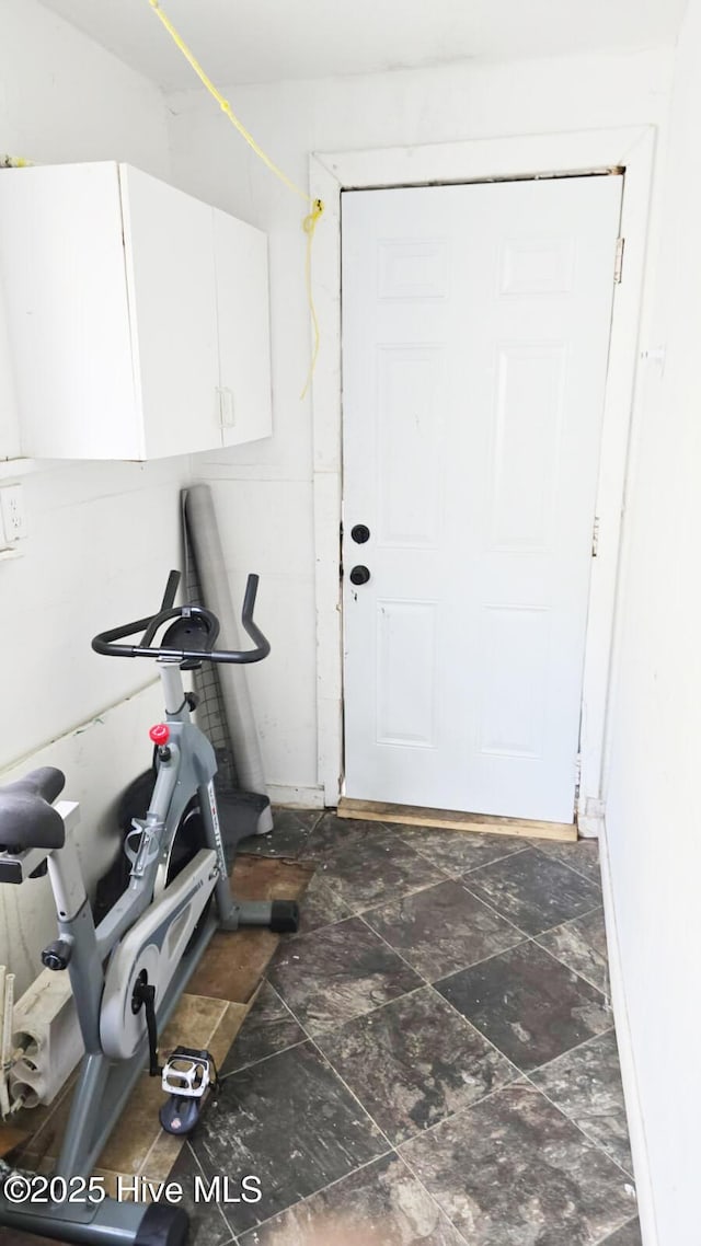 doorway to outside featuring dark stone finish flooring