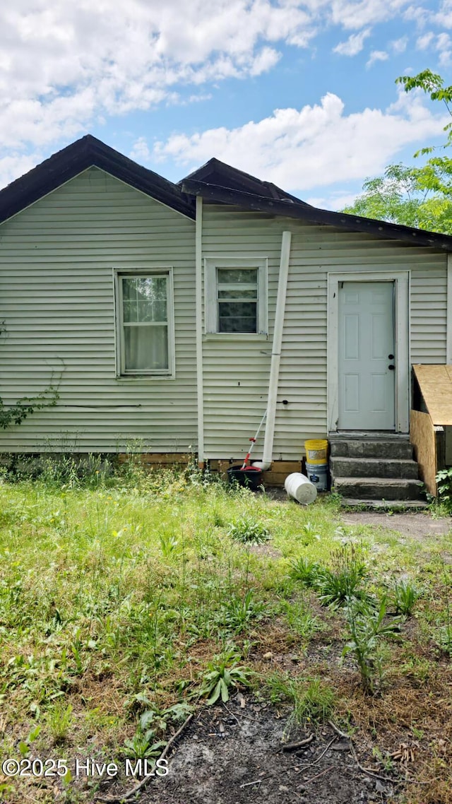 rear view of house featuring entry steps