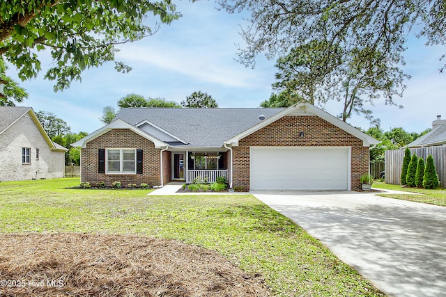 ranch-style home featuring brick siding, an attached garage, covered porch, and driveway