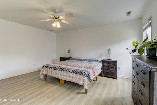 bedroom with light wood-style floors, baseboards, and a ceiling fan