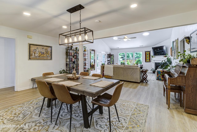 dining room featuring light wood-style flooring, ceiling fan, vaulted ceiling, baseboards, and recessed lighting