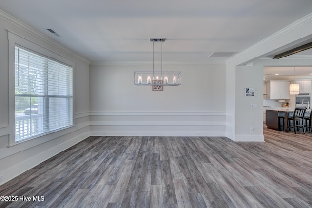 374 Yucca Ln, Wilmington, NC 28412 - unfurnished dining area with ornamental molding, a chandelier, dark wood-style flooring, and baseboards