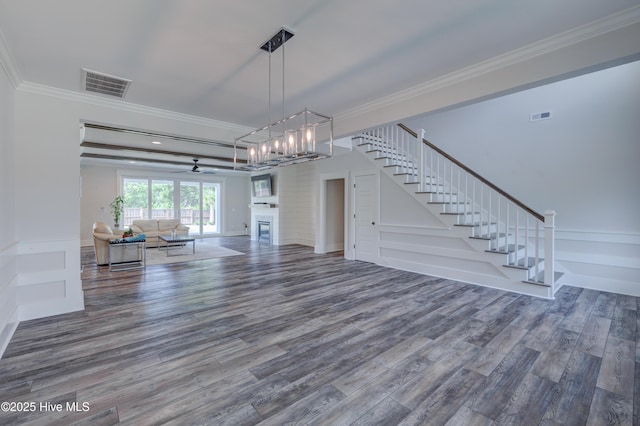 374 Yucca Ln, Wilmington, NC 28412 - unfurnished living room with wood finished floors, crown molding, stairway, and a chandelier