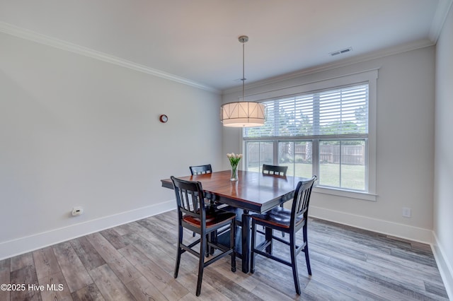 374 Yucca Ln, Wilmington, NC 28412 - dining room with baseboards, crown molding, and wood finished floors