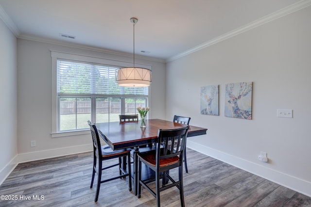 374 Yucca Ln, Wilmington, NC 28412 - dining space with plenty of natural light, wood finished floors, baseboards, and ornamental molding