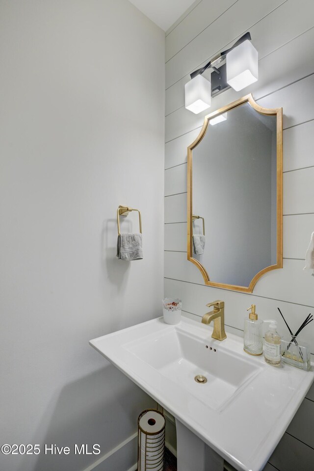 374 Yucca Ln, Wilmington, NC 28412 - bathroom featuring wood walls and a sink