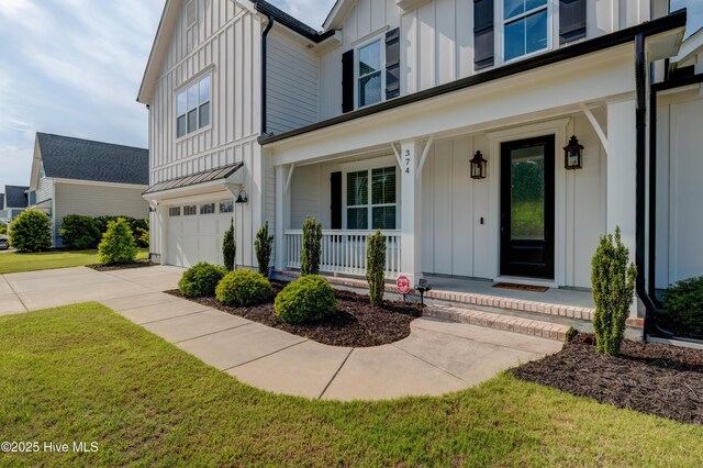 374 Yucca Ln, Wilmington, NC 28412 - entrance to property with board and batten siding, covered porch, and an attached garage