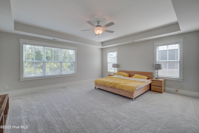 374 Yucca Ln, Wilmington, NC 28412 - carpeted bedroom featuring a raised ceiling, baseboards, and a ceiling fan