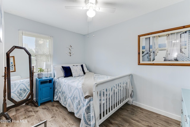 bedroom featuring wood finished floors, baseboards, and a ceiling fan