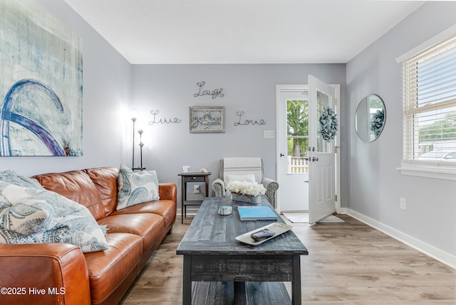 living room with light wood finished floors and baseboards