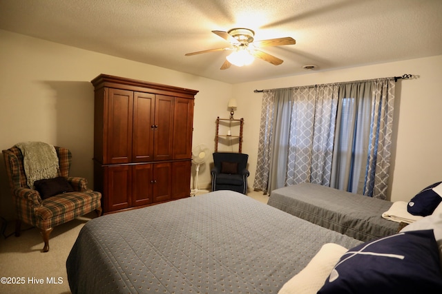 bedroom featuring light carpet, a ceiling fan, and a textured ceiling