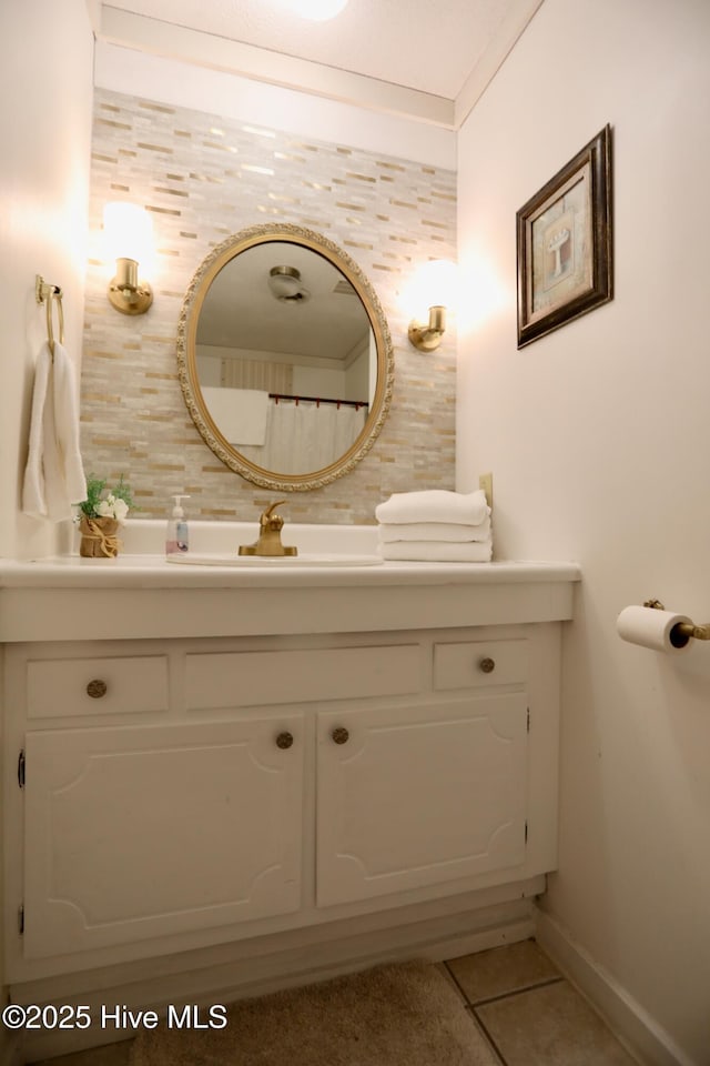 bathroom with tile patterned flooring, vanity, and baseboards