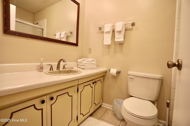full bathroom with tile patterned flooring, toilet, vanity, and baseboards