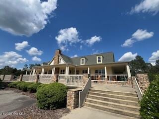 view of front of house featuring a porch and stairs