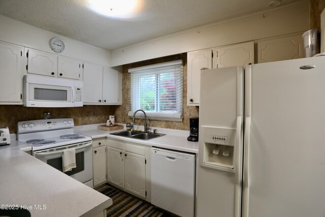 kitchen featuring white appliances, a sink, light countertops, white cabinets, and a textured ceiling