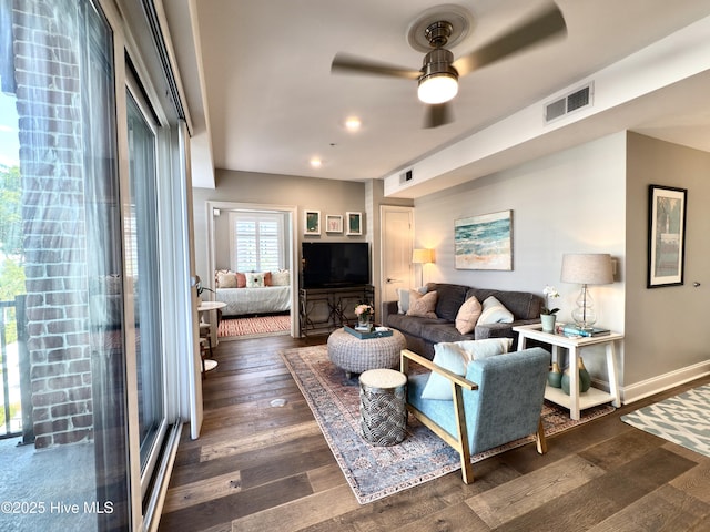 living room with visible vents, a ceiling fan, dark wood-type flooring, and recessed lighting