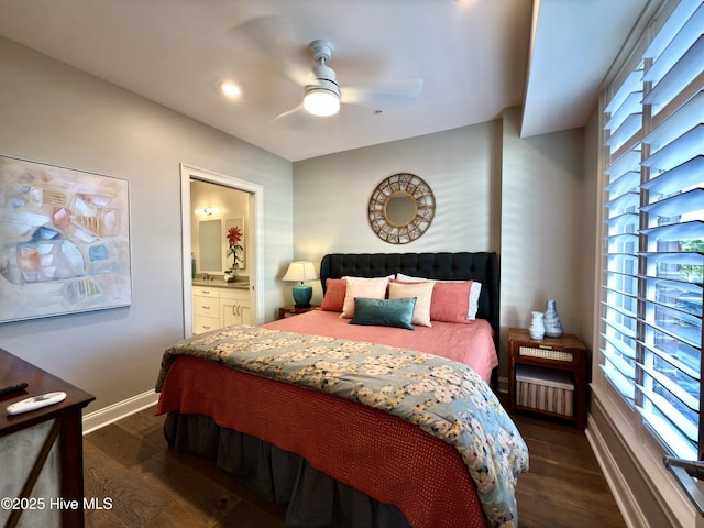 bedroom with ensuite bath, dark wood-style flooring, baseboards, and a ceiling fan