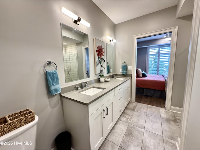 full bathroom featuring toilet, tile patterned flooring, a sink, and a shower stall