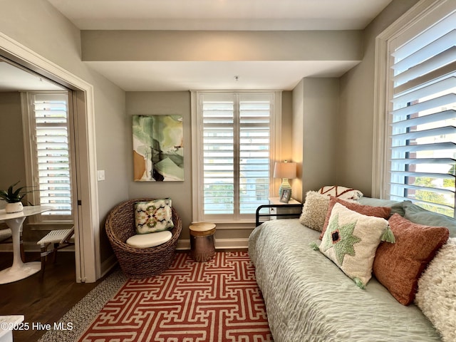 interior space featuring baseboards and wood finished floors