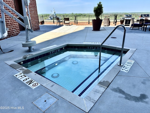 view of pool featuring a patio area, a hot tub, and fence