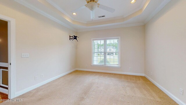 spare room featuring a ceiling fan, light carpet, a tray ceiling, and recessed lighting