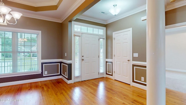 entryway with a notable chandelier, visible vents, light wood-type flooring, and plenty of natural light