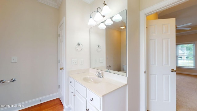bathroom with baseboards, vanity, and crown molding