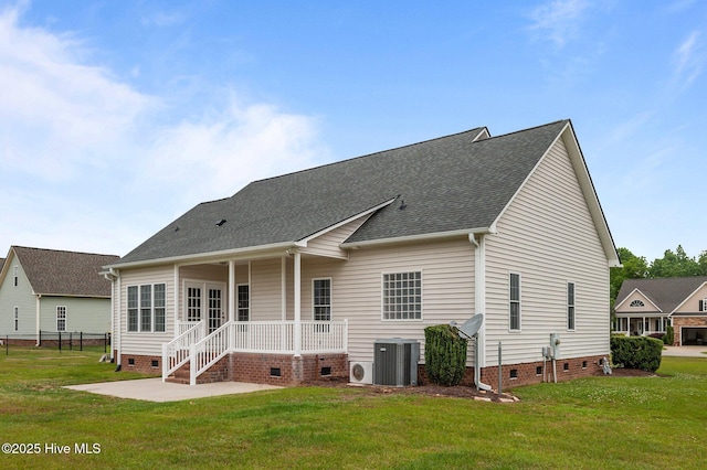 rear view of property featuring central air condition unit, a yard, and crawl space