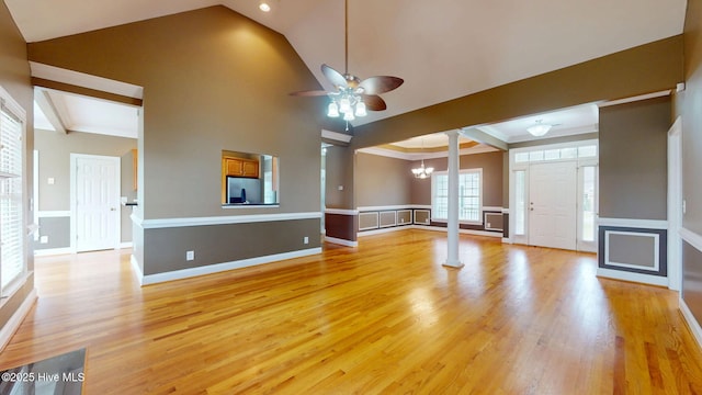 unfurnished living room featuring ceiling fan, baseboards, ornate columns, and light wood-style floors