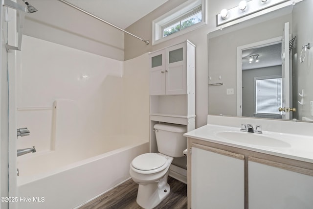 full bath featuring toilet, vanity, tub / shower combination, and wood finished floors