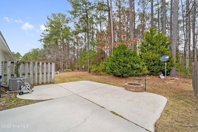 view of patio featuring an outdoor fire pit, fence, and central air condition unit