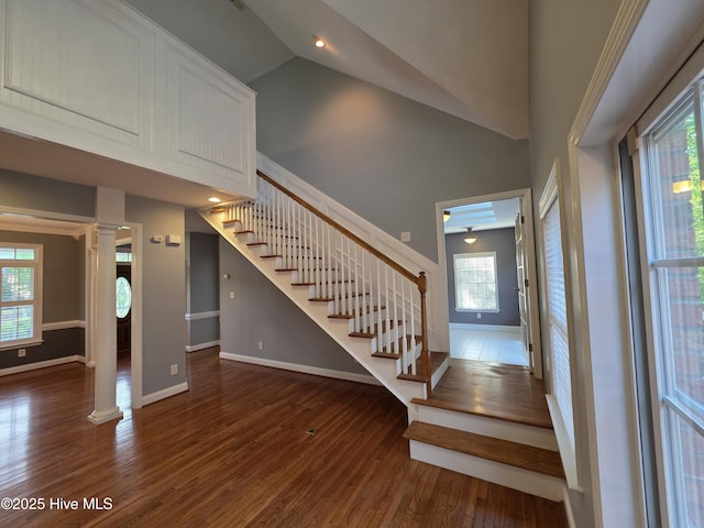 219 Drake Lndg, New Bern, NC 28560 - staircase featuring baseboards, wood finished floors, decorative columns, and high vaulted ceiling