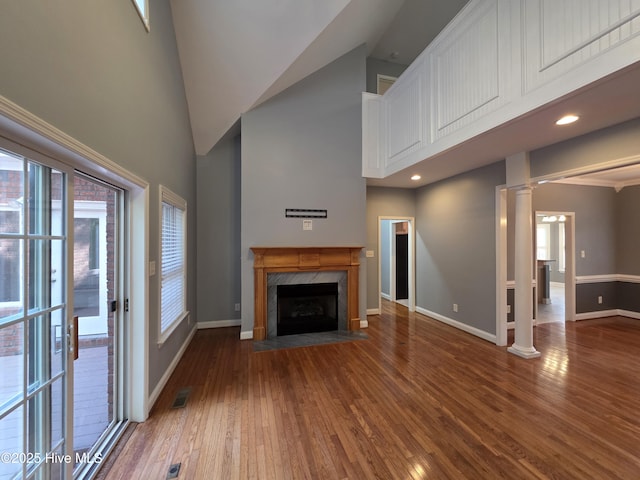 219 Drake Lndg, New Bern, NC 28560 - unfurnished living room featuring wood finished floors, visible vents, baseboards, and a high ceiling