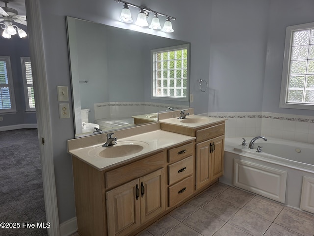 219 Drake Lndg, New Bern, NC 28560 - full bathroom with a sink, a garden tub, and plenty of natural light