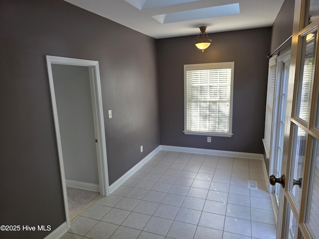 219 Drake Lndg, New Bern, NC 28560 - unfurnished room featuring light tile patterned floors, baseboards, a skylight, and a healthy amount of sunlight