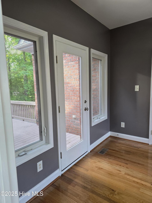 219 Drake Lndg, New Bern, NC 28560 - doorway featuring visible vents, wood finished floors, and baseboards