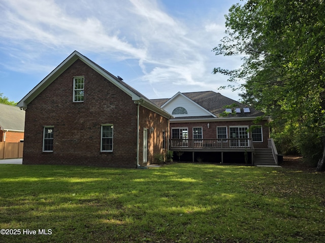 219 Drake Lndg, New Bern, NC 28560 - back of property featuring brick siding, a wooden deck, and a lawn