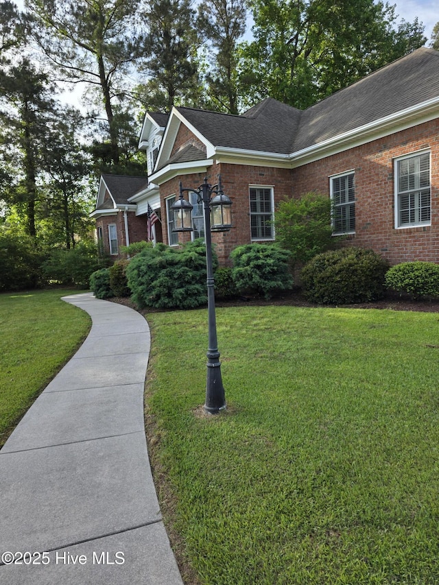 219 Drake Lndg, New Bern, NC 28560 - exterior space with a yard, brick siding, and roof with shingles